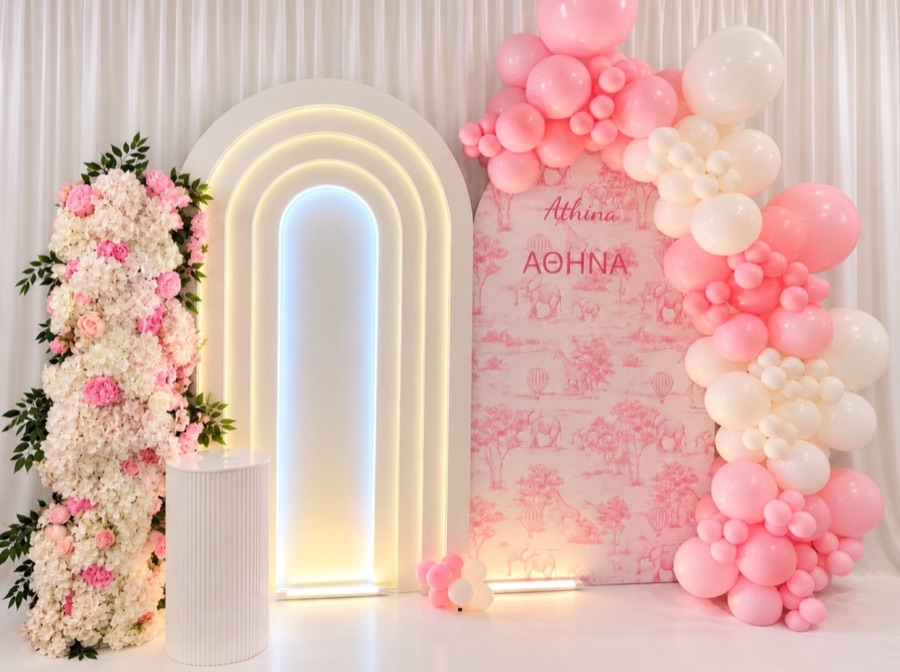 Pink toile panel and lit white arch with pink and white balloon garland